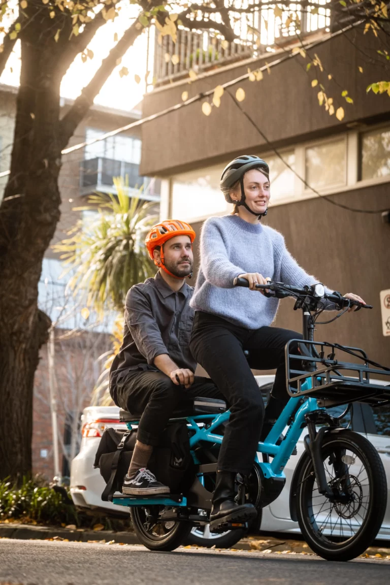 A couple riding their subscription ebike to date night in brisbane